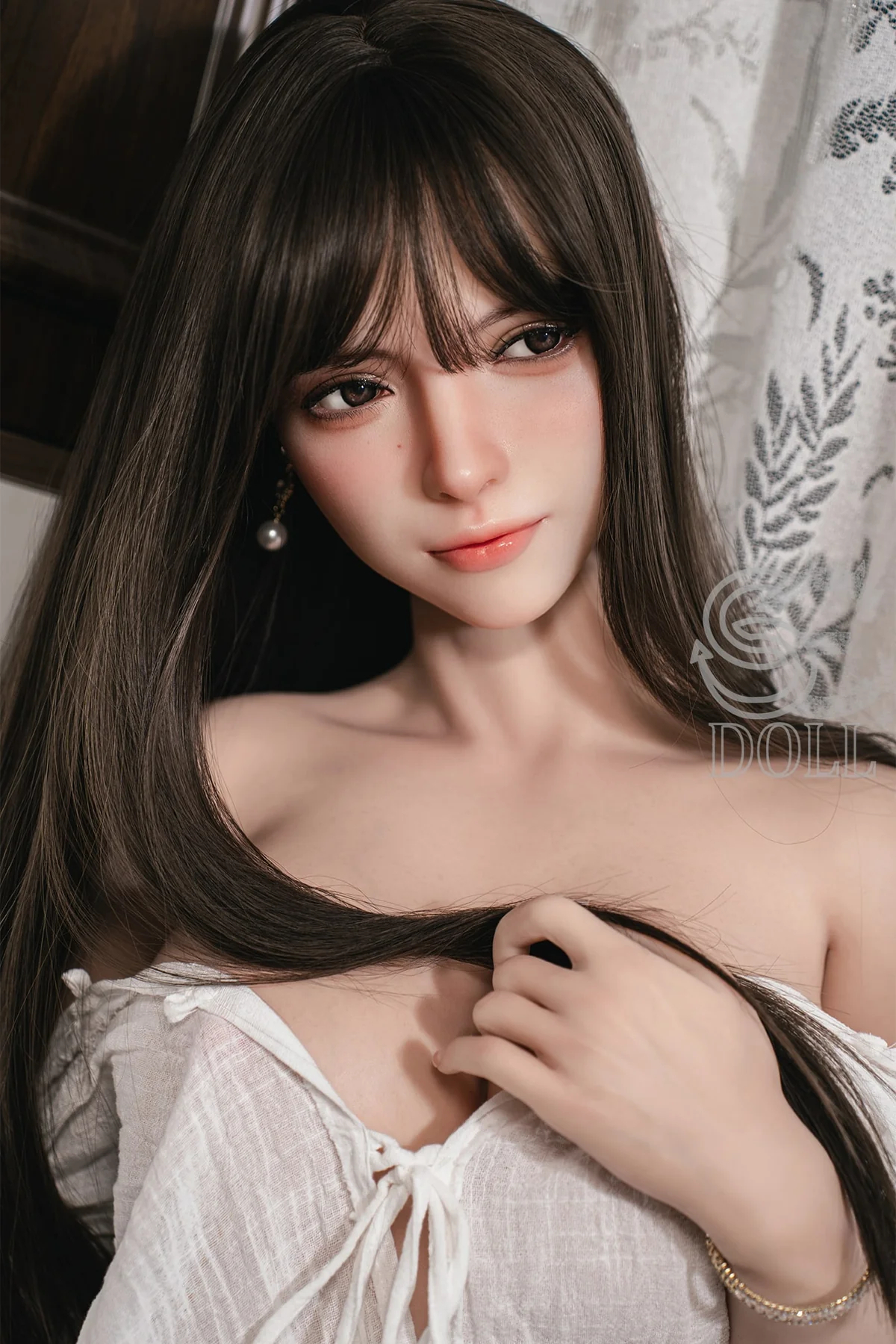 Intime Real Doll mit langen schwarzen Haaren und natürlichem Gesichtsausdruck im Schlafzimmer